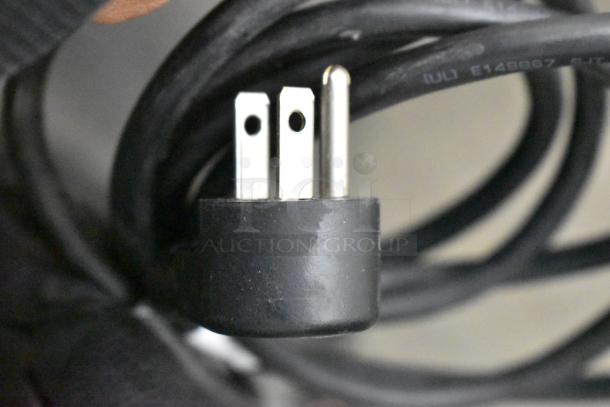 Close-up of a three-prong power plug attached to the 2020 Delfield 406P-STAR2 Undercounter Cooler, 115V, 1 Phase.