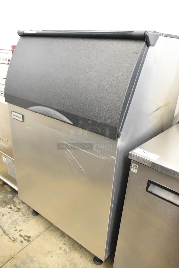 2023 Ice-O-Matic B55PSC stainless steel commercial ice bin with minor surface scratches, black lid, and Ice-O-Matic logo.