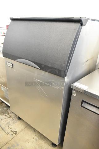 2023 Ice-O-Matic B55PSC stainless steel commercial ice bin with minor surface scratches, black lid, and Ice-O-Matic logo.