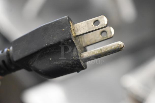 Close-up of a worn black power plug for the Leadway ET-99SU Cup Sealing Machine. 110/120 Volts, 1 Phase.