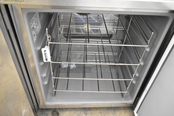 2019 Delfield 406P-STAR2 stainless steel undercounter cooler in good condition, interior view with shelving and cooling tag visible.