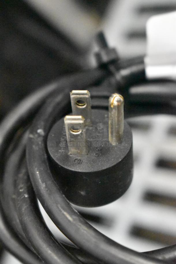 Close-up of a power plug for the 2019 Delfield 406P-STAR2 undercounter cooler, 115 volts, 1 phase, on commercial casters.