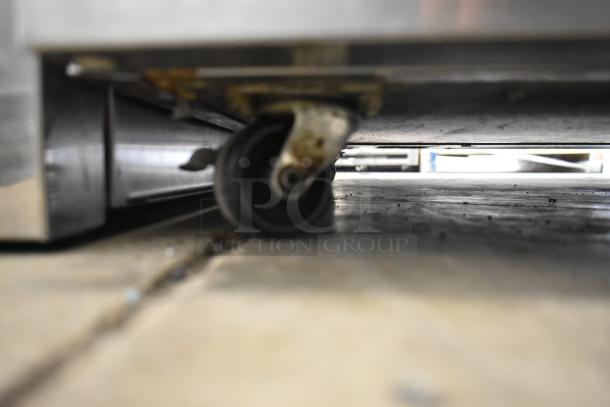 2019 Delfield 406P-STAR2 stainless steel undercounter cooler on commercial casters, 115V, 1 Phase, with visible wheel.