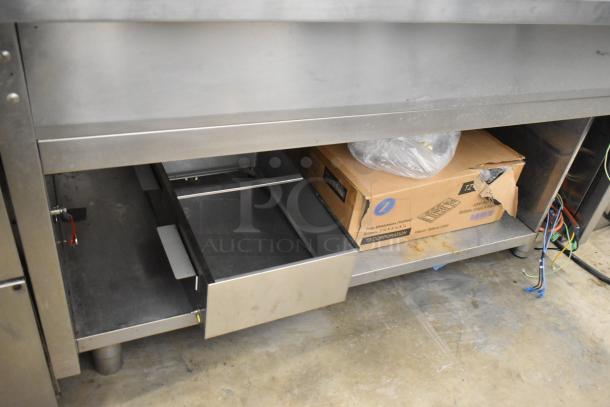 Stainless Steel Commercial Steam Table with storage drawer, lower shelf, and visible wiring. Used condition, sturdy build.