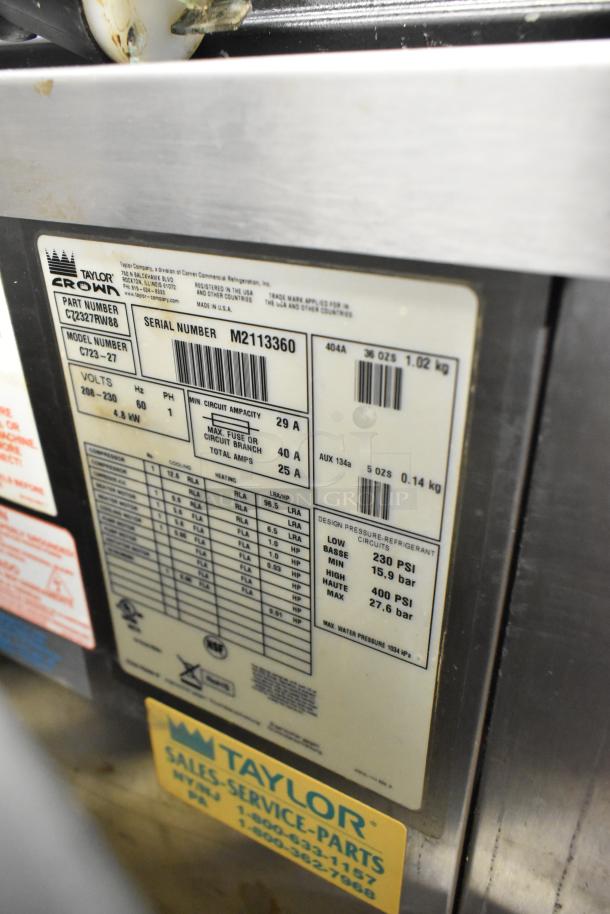 Taylor C723-27 stainless steel 2-flavor soft serve machine label. Voltage 208-230, phase 1, serial M2113360.