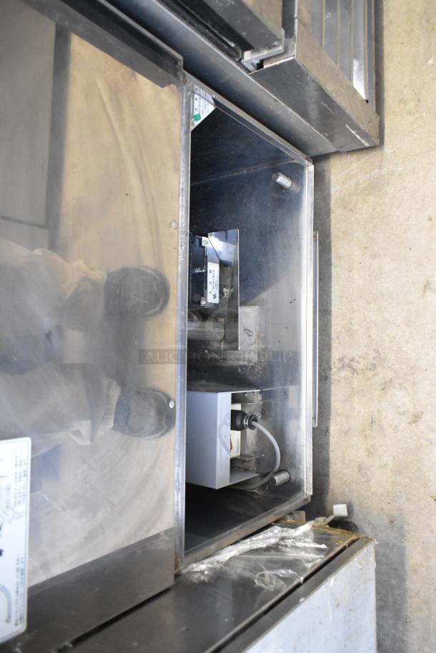 Ricemini RM-401AG rice washing machine, metal body. 100 Volts, 1 Phase. Visible markings for controls and specifications.