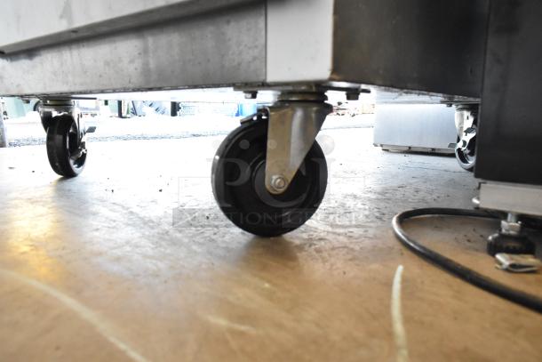 2022 Traulsen SB1G-10010-032A reach-in cooler on commercial casters. Stainless steel construction, poly-coated racks.