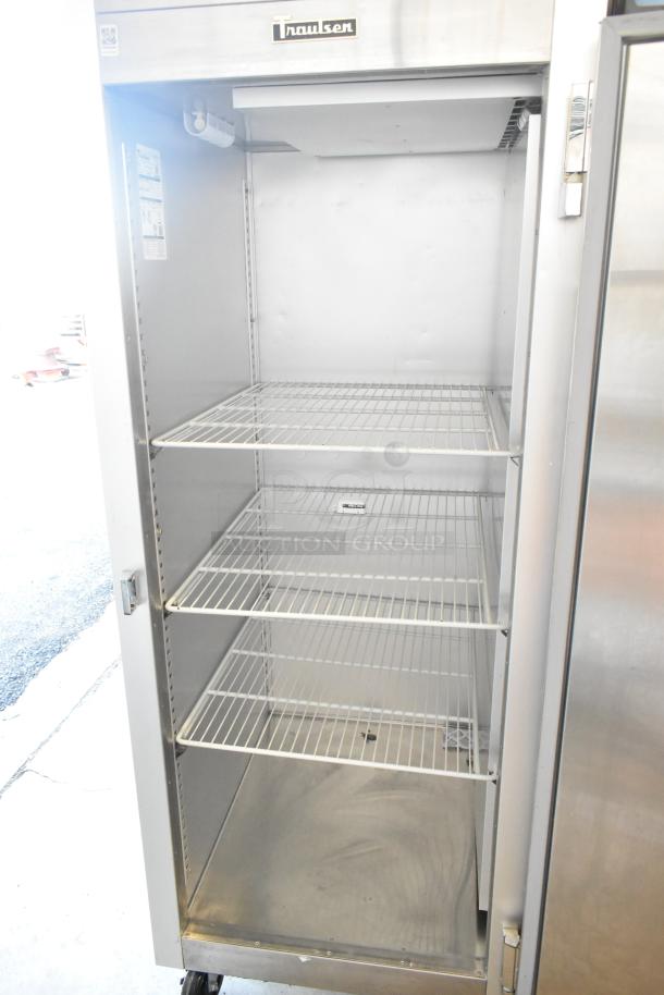 2022 Traulsen SB1G-10010-032A stainless steel single door reach-in cooler with poly coated racks, on commercial casters.