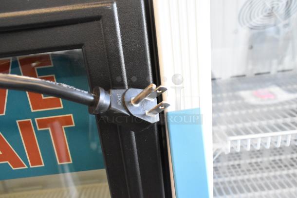 True GDM-12 single-door cooler merchandiser, features poly-coated racks, 115 volts, 1-phase plug visible.