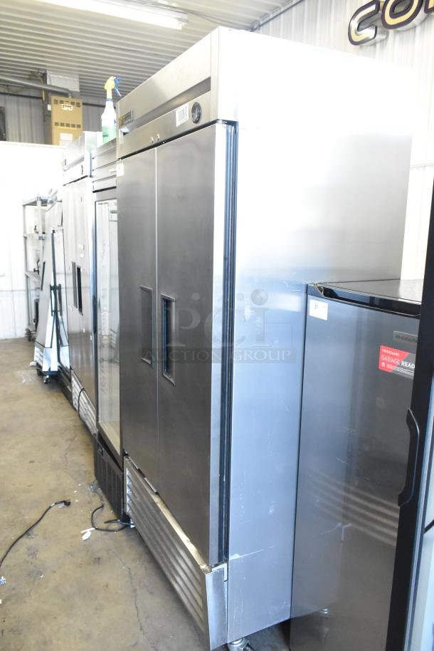 True T-35 stainless steel commercial 2-door reach-in cooler with poly coated racks, on casters. 115 volts, 1 phase.