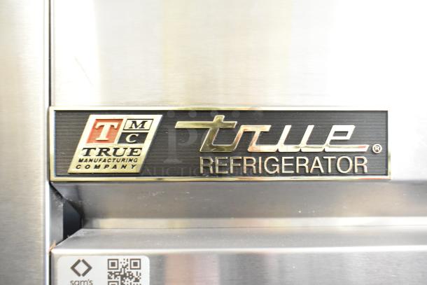 True T-35 stainless steel commercial 2-door cooler with poly coated racks and commercial casters. Model label visible.