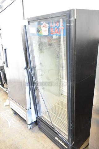 True GDM-12 metal commercial cooler, single glass door, 115 volts, live bait sticker, wire shelves, black frame.