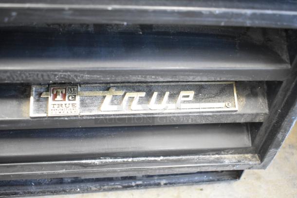 True GDM-12 commercial cooler, metal, single door, 115 volts, 1 phase. True logo visible, moderate wear.