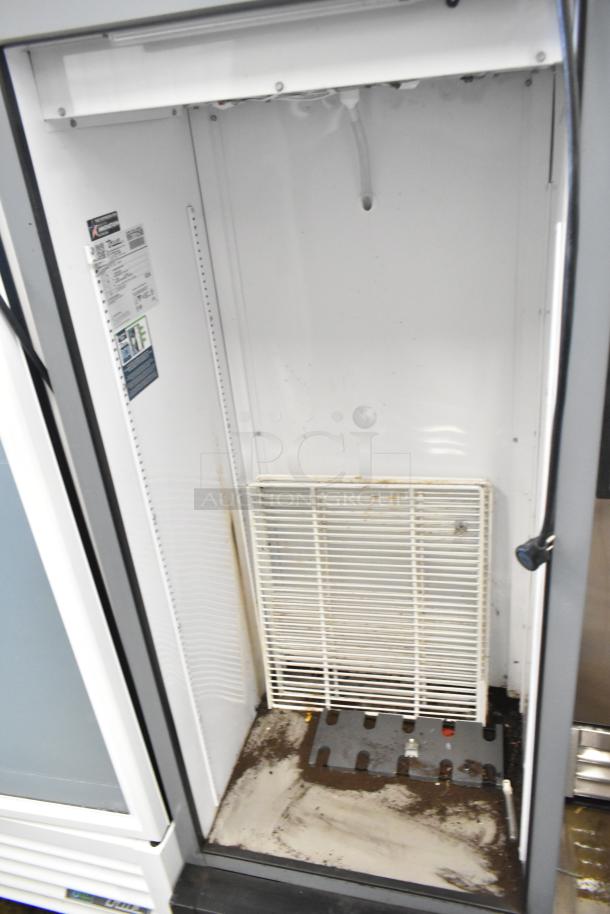 2020 True GDM-12-HC single door cooler. Door needs reattachment. Features 115 volts, 1 phase. Interior has visible wear.