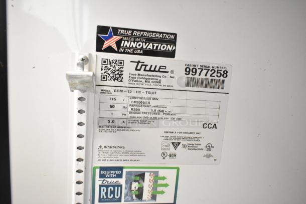 2020 True GDM-12-HC cooler merchandiser, single door, metal, needs door reattachment, 115 volts, 1 phase. Labels show model and specs.