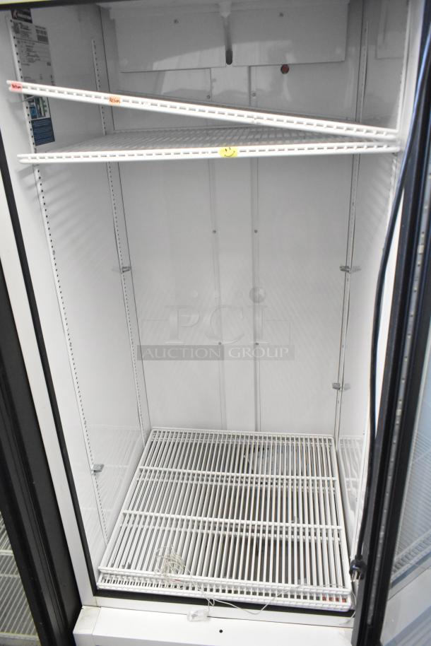 True 2021 TSCI-600R-G-PH metal single-door cooler, poly-coated racks, 115V, 1 phase; features shelves for merchandising.