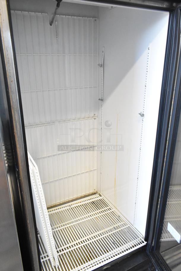 2017 True GDM-26F-HC metal freezer merchandiser with poly coated racks; inside view shows clean interior.