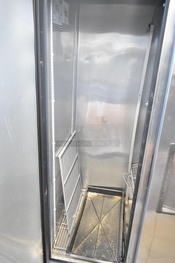 2016 True T-35 stainless steel 2-door reach-in cooler with poly-coated racks shown inside. Model T-35, on commercial casters.