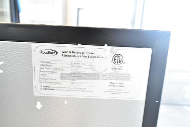 KoolMore KM-BIR3C-GD stainless steel glass-door refrigerator label showing model, voltage, weight, and safety warnings.