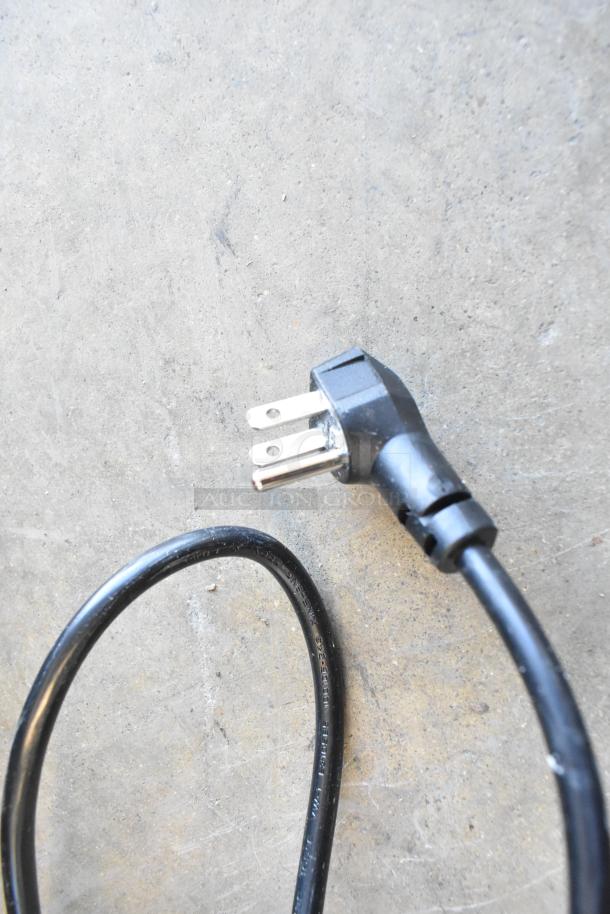 Alt text: 

Close-up of a black power cord with a three-prong plug for KoolMore KM-BIR3C-GD refrigerator.