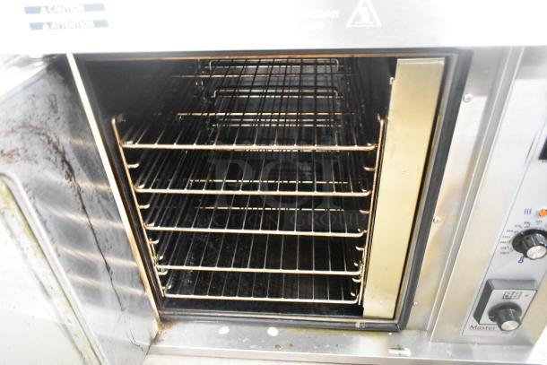 2025 Garland MCO-E-5-C stainless steel convection oven with view-through door, metal racks, and thermostatic controls.