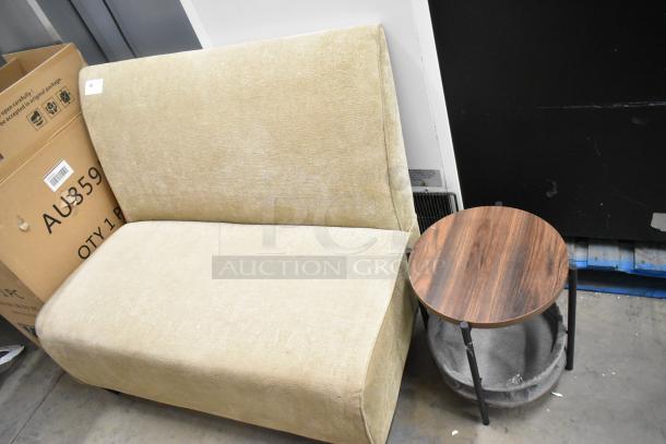Beige single-sided booth seat with a light texture, paired with a round wooden end table on metal legs. Appears in good condition.