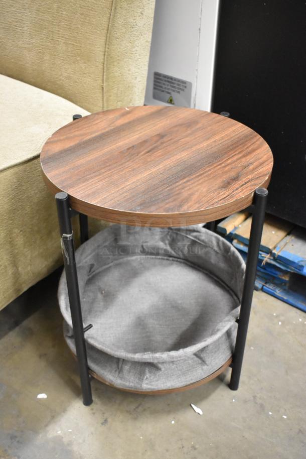 Single-sided booth seat with textured beige fabric and a round wooden end table featuring a fabric storage shelf.