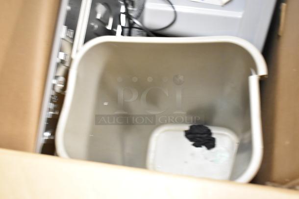 Lot of various items including a paper towel dispenser, keyboard, and trash can. Items appear used.