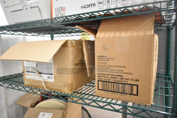 Box of Philips lightbulbs on a metal shelf, partially open, includes labels; potential bulk purchase.