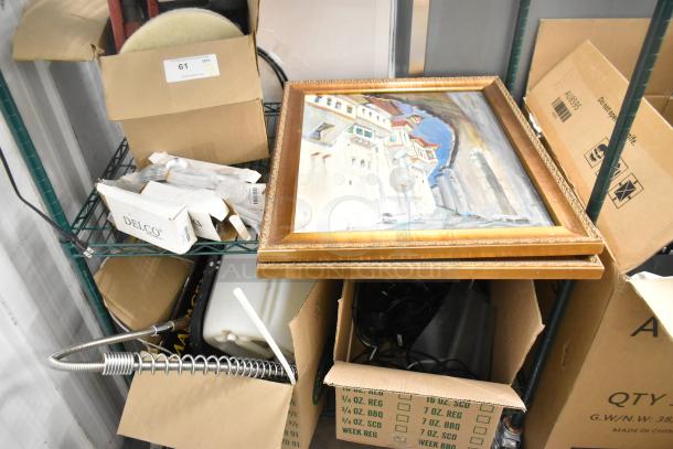 Two-tier shelving with various items including Delco dinner knives, framed painting, and boxes; mixed lot auction.