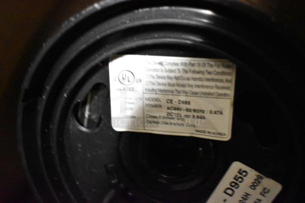 Blurred image showing a product's label with UL listing, Model: GE-D955, and details about power and manufacture in Korea.