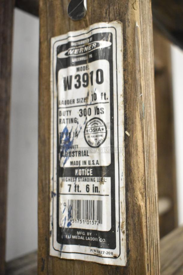 Werner W3910 10' wooden A-frame ladder, 300 lbs duty rating, industrial use, visible wear, label states "Made in USA."