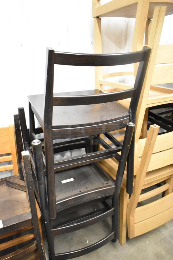 16 various wooden dining height chairs stacked, featuring different finishes. Key condition details visible.