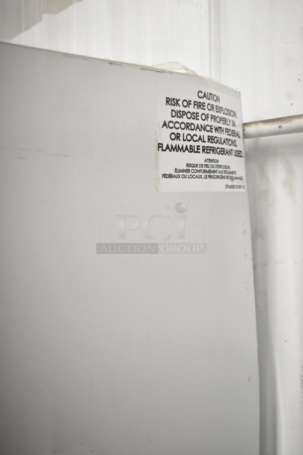 2022 Traulsen SB1G-10011-032A stainless steel reach-in cooler with poly-coated racks, caution label visible.