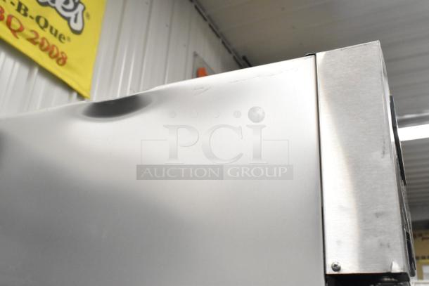 2023 True T-23F-HC stainless steel freezer, single door, visible dent on top, poly-coated racks, on commercial casters.