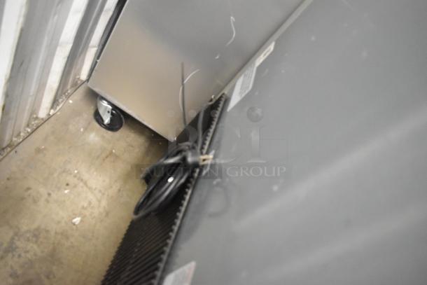 2020 True T-23F-HC stainless steel commercial freezer on casters, rear view showing electrical cord and poly coated racks.