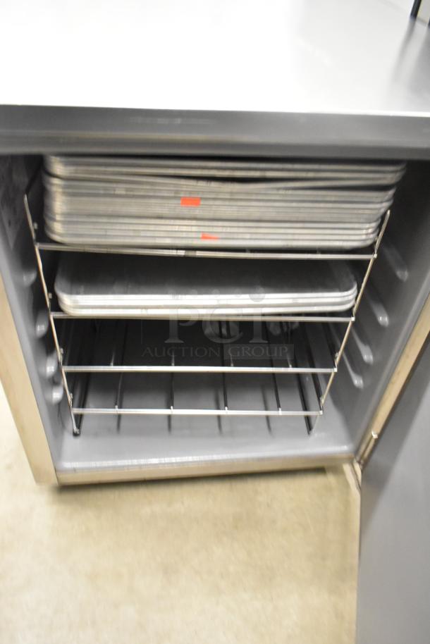 2020 Delfield 406P-STAR2 stainless steel undercounter cooler, open door showing interior racks, on commercial casters.