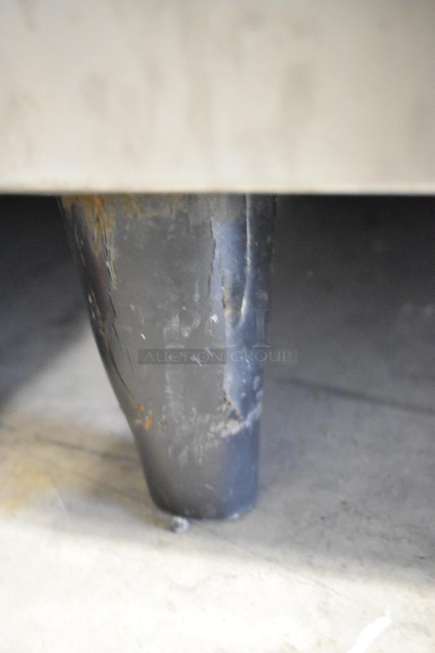 Follett metal commercial ice bin leg, showing signs of wear and rust, indicative of used condition.