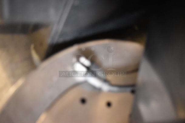 Blurred close-up of Inoksan PDG400N Gyro Machine part. Stainless steel. Condition and markings not clear.