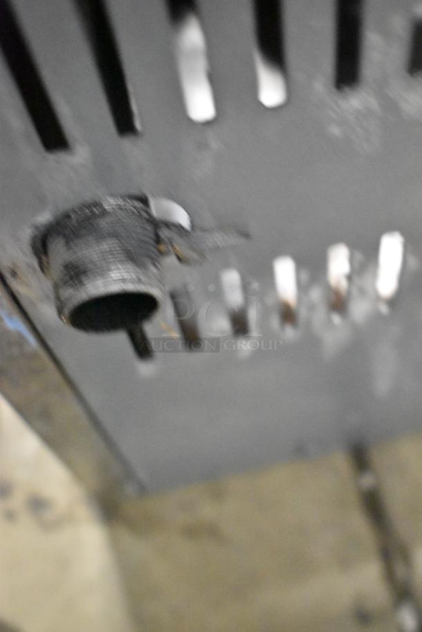 Stainless steel commercial countertop gas burner with vented side panel; shows exterior gas connection.