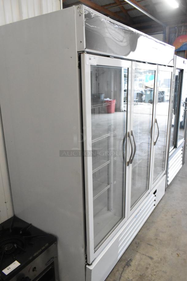 Beverage Air metal commercial 3-door reach-in cooler merchandiser with poly-coated racks, in good condition.