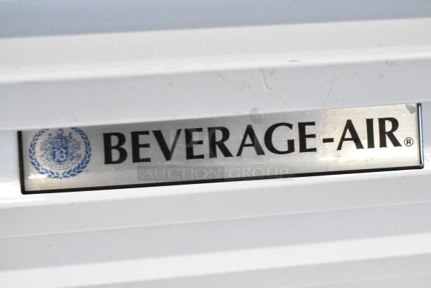 Beverage Air metal 3-door reach-in cooler, commercial use, includes poly-coated racks, visible branding plate.