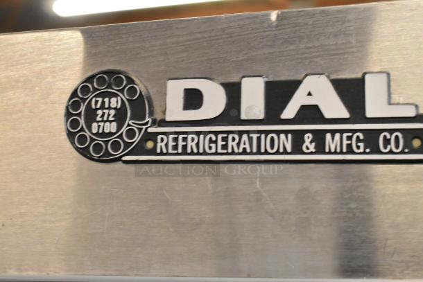 Dial Metal 2 Door Reach-In Cooler Merchandiser, 115V, 1 Phase, with poly-coated racks. Dial Refrigeration branding.