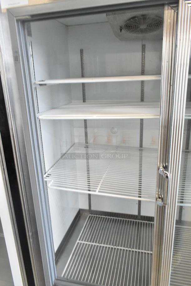 Dial commercial 2-door reach-in cooler with poly coated racks, 115 volts, 1 phase. Features metal construction, glass doors.