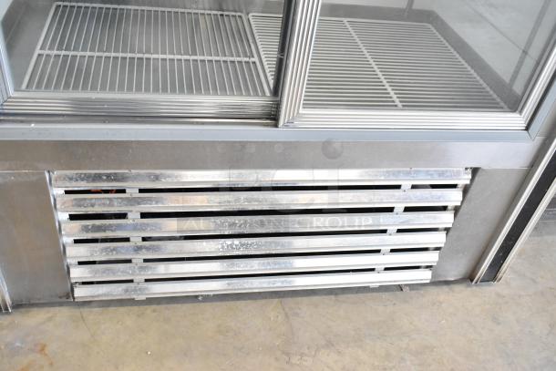 Dial Metal 2 Door Reach In Cooler with poly coated racks, 115V, 1 phase; features visible racks and lower vent panel.