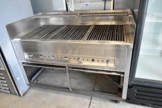 Stainless steel commercial gas grill with multiple burners, on durable casters. Featuring control knobs. Good condition.