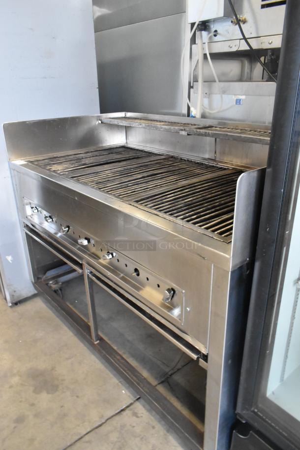 Stainless steel commercial gas grill on casters, with control knobs and spacious cooking surface.