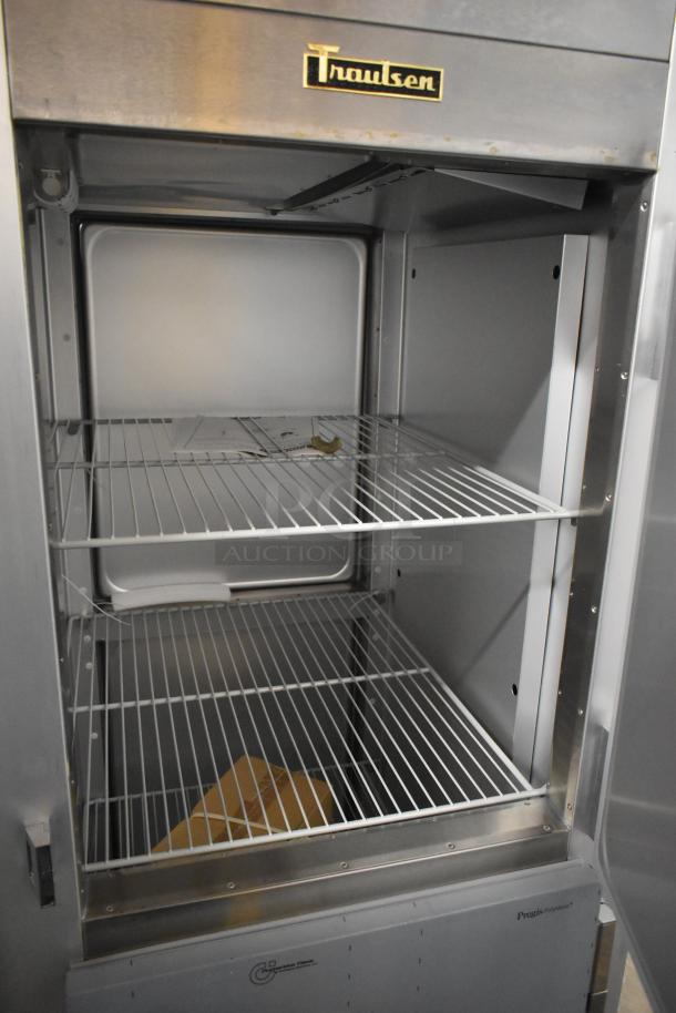 Brand new 2022 Traulsen G10042-032 stainless steel cooler with two half-size doors, poly-coated racks. Scratch and dent.