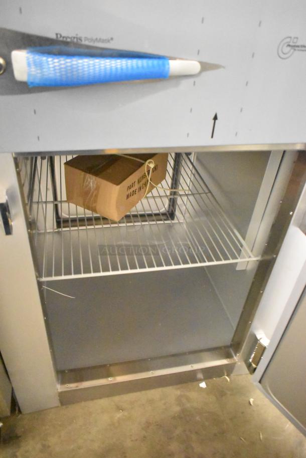 Traulsen G10042-032 stainless steel reach-in cooler with 2 half-size doors, poly-coated racks, and minor scratches. 115V, 1 Phase.