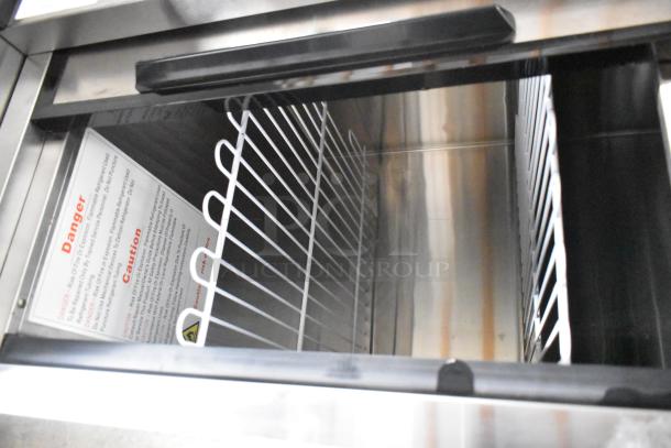 Atosa MBC50GR stainless steel bottle cooler, interior view, showing wire shelves and caution label. Brand new, 2023 model.